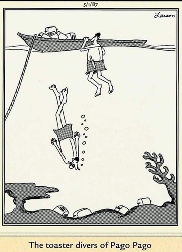 Two divers explore underwater near a boat and coral.