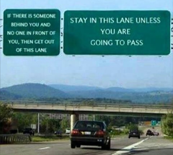 Funny highway sign giving odd instructions about lane behavior.